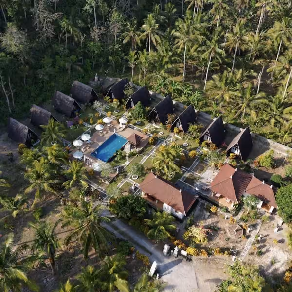Aerial view of Mahaloka Valley Resort bungalows, swimming pool and tropical gardens near Crystal Bay Beach, Nusa Penida Bali